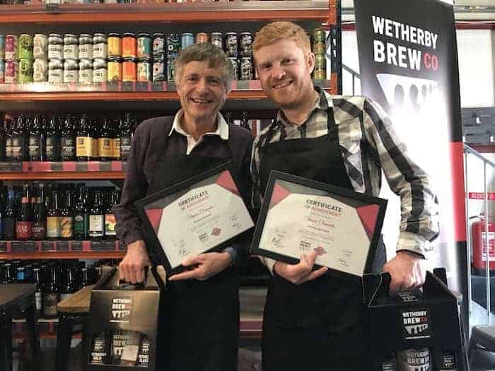 Wetherby Brew Co brewing experience guests holding a certificate