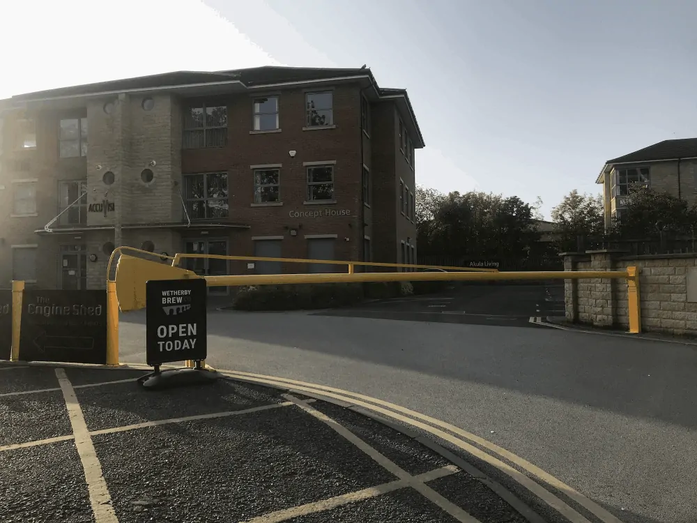 The entrance gate to York Road Estate, Wetherby with a yellow barrier that is closed